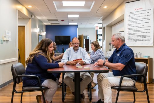 People Playing Card Game at Gateway Foundation Aurora