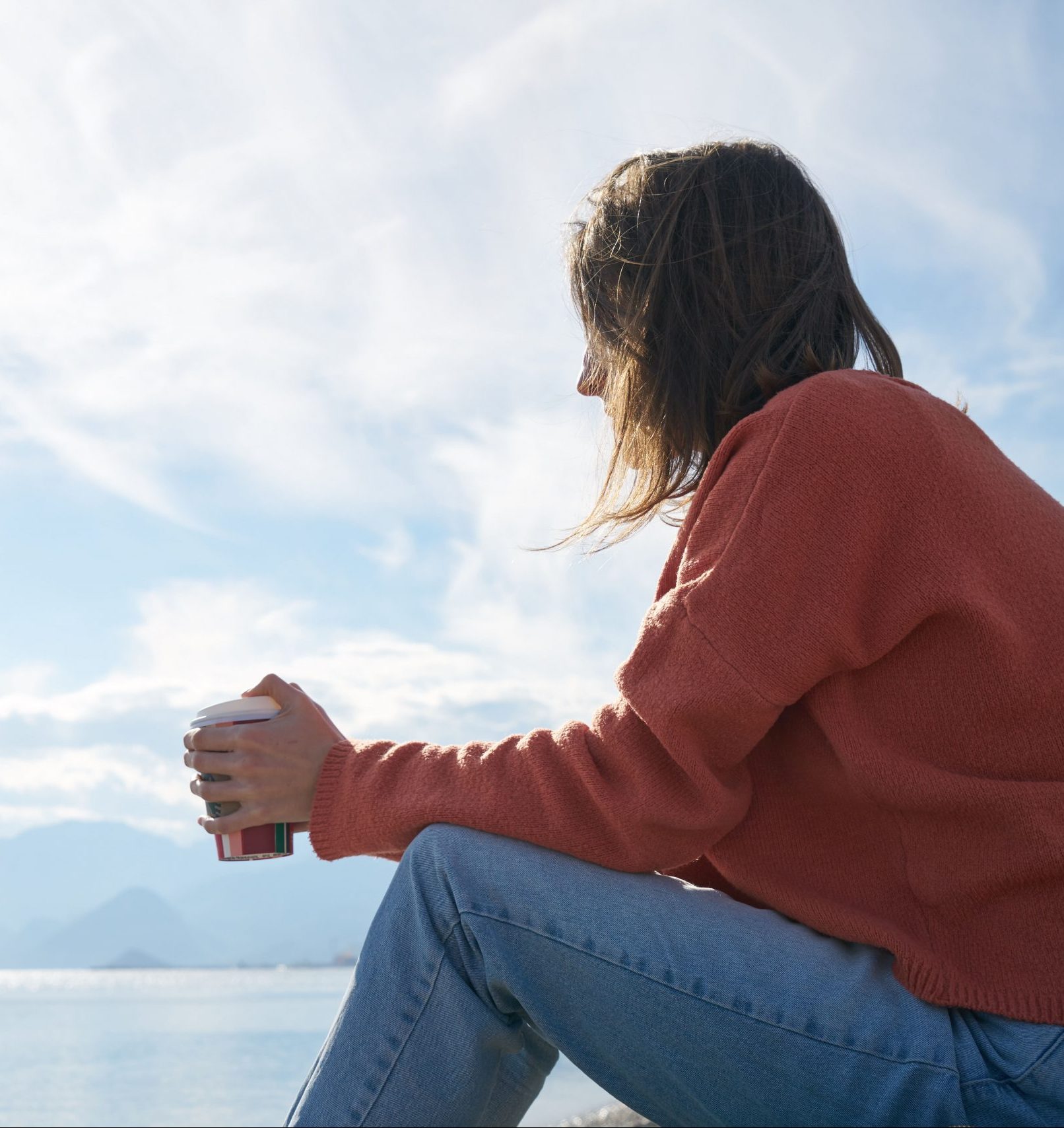 women sitting outside drinking coffee