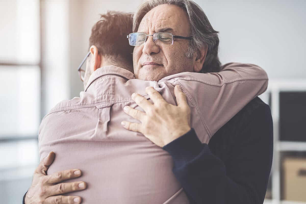 father hugging son