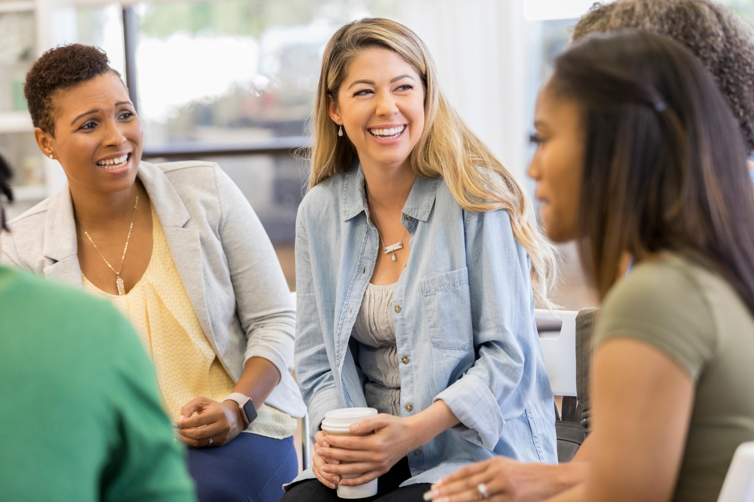 woman sitting in a circle talking together