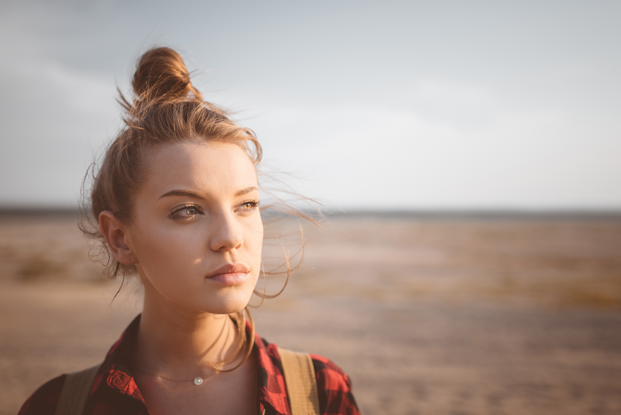 young woman standing in field