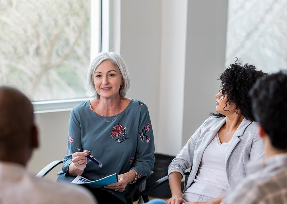 Therapist leading a group therapy session