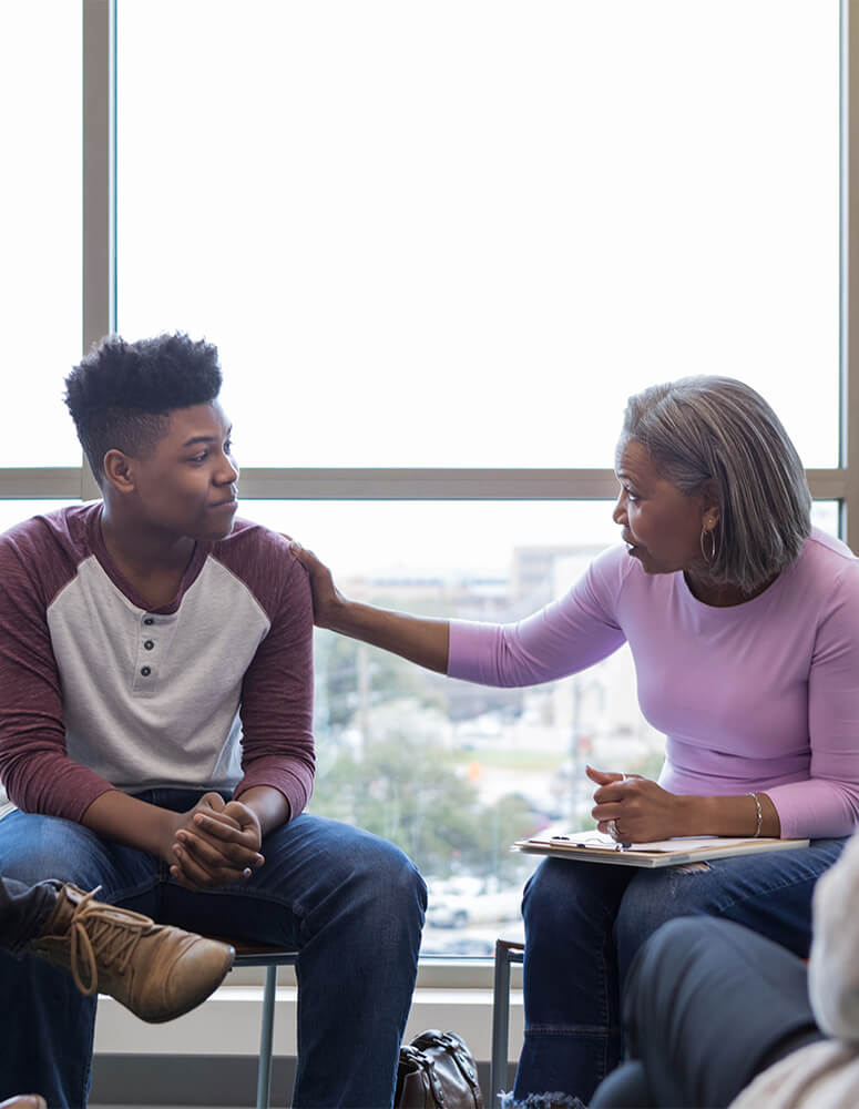 Therapist talking to teen boy