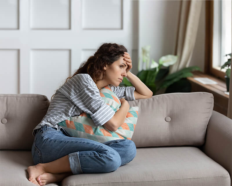 Depressed woman looking out window