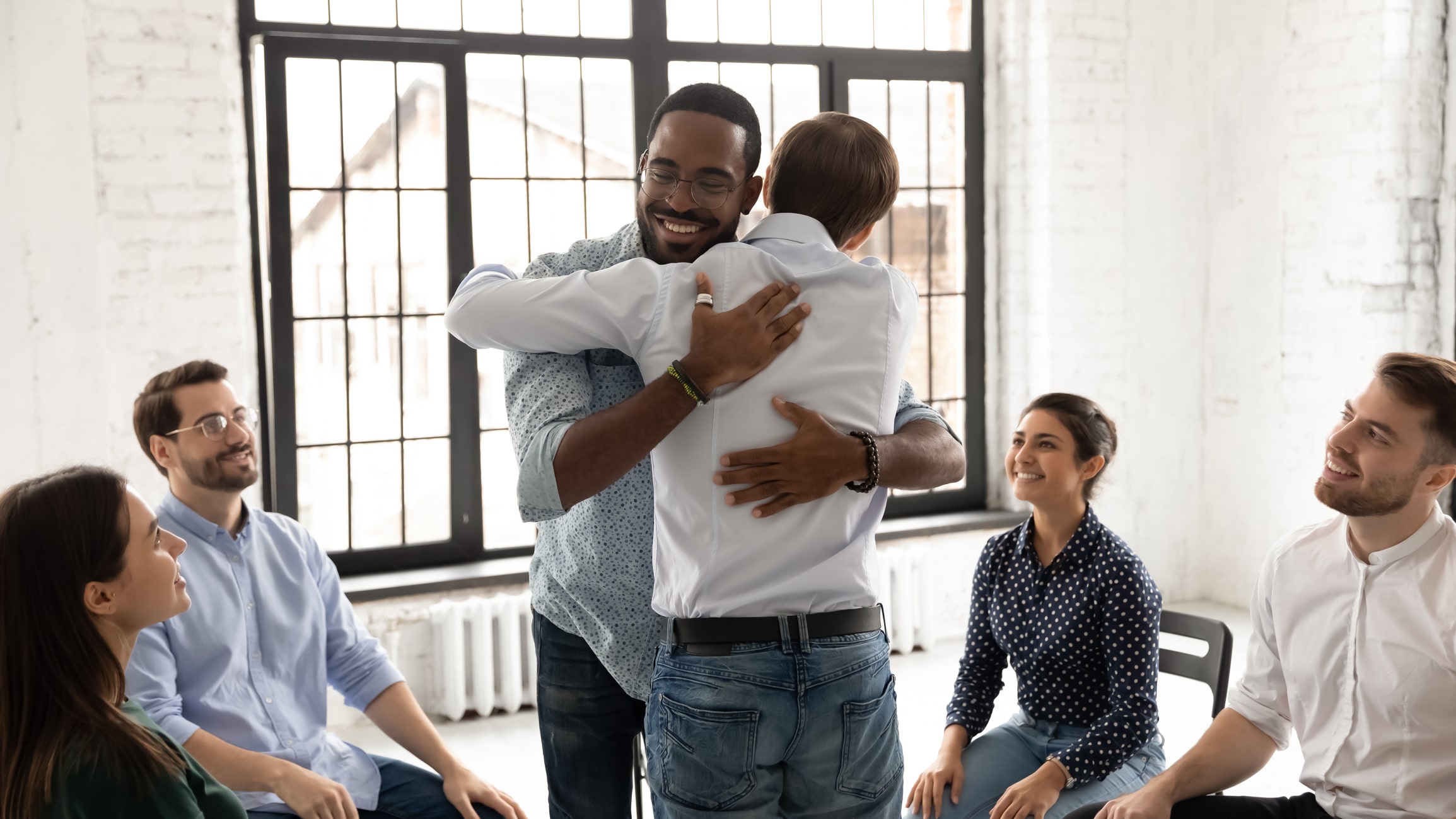 Two men hugging each other