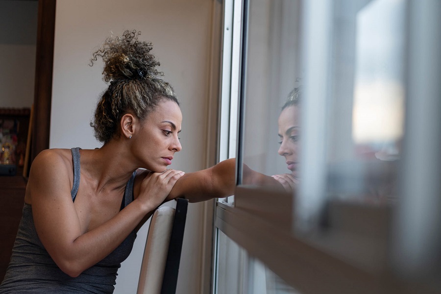 woman sitting looking out a window