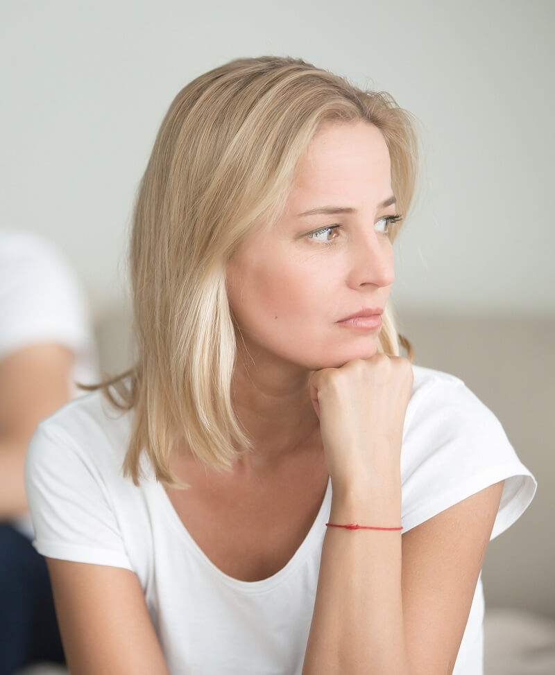 woman sitting down contemplating something